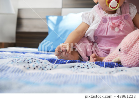 Baby touching her feet 48961228