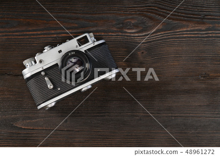 Vintage camera on a grungy wooden background 48961272
