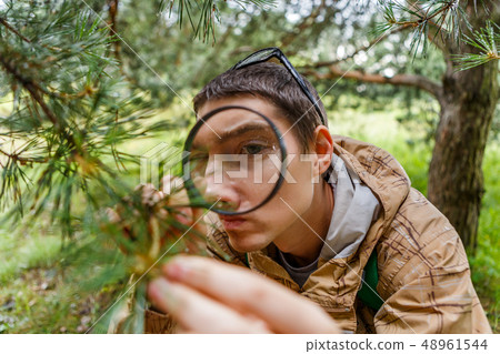 Picture of brunet with magnifying glass 48961544