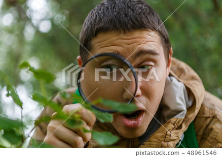Photo of young botanist with magnifying glass 48961546