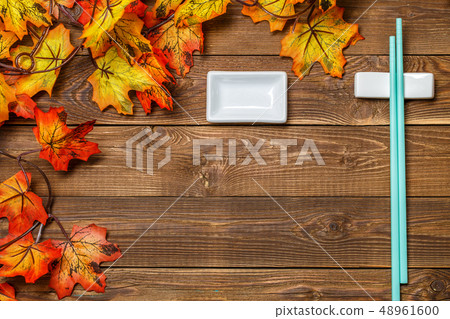 Wooden background with maple leaves Wooden background with maple leaves 48961600