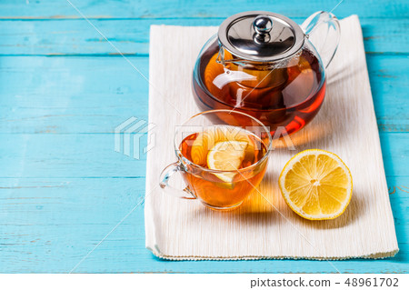 Glass cup of tea with lemon and glass teapot. Glass cup of tea with lemon and glass teapot. 48961702