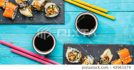Sushi, multi-colored sticks at table 48961879