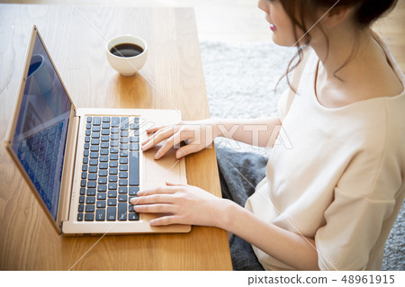 A woman looking at a computer A woman looking at a computer 48961915