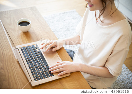 A woman looking at a computer A woman looking at a computer 48961916
