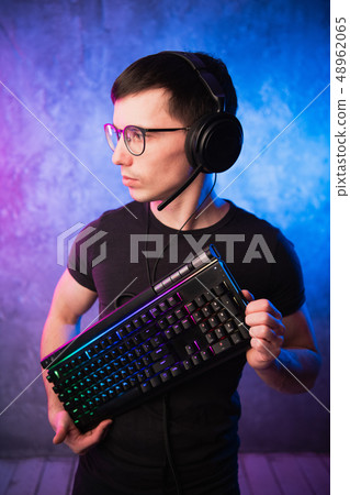 Technology, cyberspace, programming and people concept - hacker man in headset and eyeglasses with Technology, cyberspace, programming and people concept - hacker man in headset and eyeglasses with 48962065