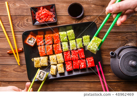 Sushi Set rolls with soy sauce served on black plate 48962469