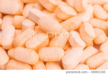 Heap of Vitamin C tablets 48963160