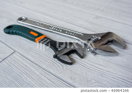 two adjustable wrenches on the table close up 48964166