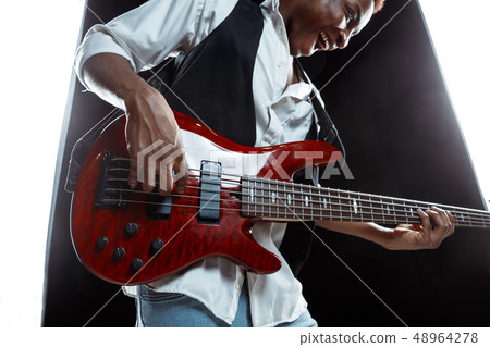 African American jazz musician playing bass guitar. 48964278