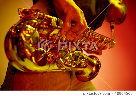 African American jazz musician playing the saxophone. African American jazz musician playing the saxophone. 48964503