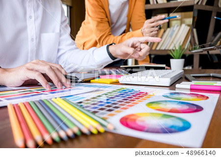 Two colleagues creative graphic designer working on color select Two colleagues creative graphic designer working on color select 48966140