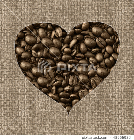 Heart symbol of coffee beans isolated on beige fabric background. Heart symbol of coffee beans isolated on beige fabric background. 48966923