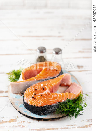 Two raw fresh salmon on a white background. 48967032