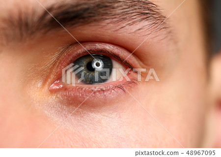 Male left blue grey coloured eye extreme closeup 48967095
