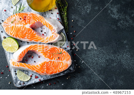 Two raw fresh salmon or trout steaks. Two raw fresh salmon or trout steaks. 48967153
