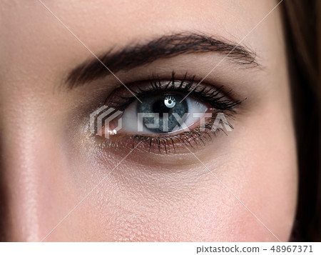 Female left green coloured eye extreme closeup 48967371