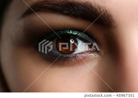 Female left green coloured eye extreme closeup 48967381