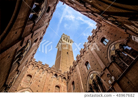 View from the courtyard of Siena town hall Palazzo Pubblico to Mangia Tower Torre del Mangia and View from the courtyard of Siena town hall Palazzo Pubblico to Mangia Tower Torre del Mangia and 48967682