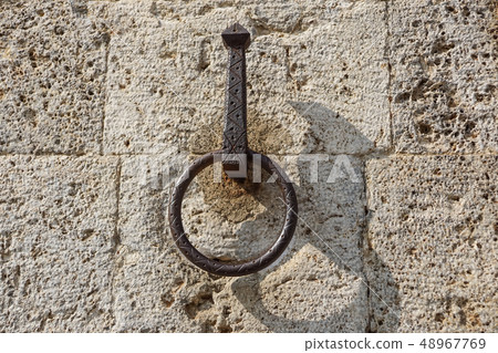 Metal door ring on the wall. Head Knocker. 48967769