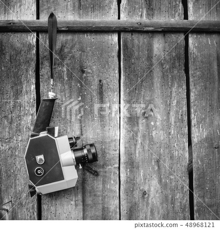 Vintage film camera on wooden wall. Concept - movie of the 1970s-1980s 48968121