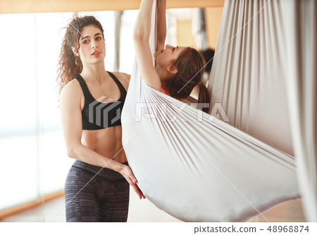 group of people engaged in a class of yoga Aero  48968874