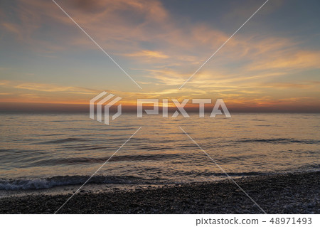 Sunset on a beautiful sky on a deserted seashore Sunset on a beautiful sky on a deserted seashore 48971493