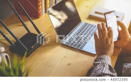 Young man Connecting router wifi On smartphone  48972395