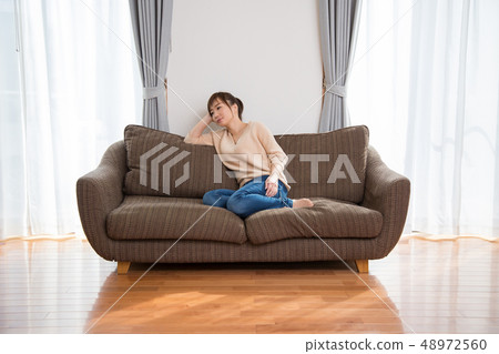Woman sitting on the couch 48972560