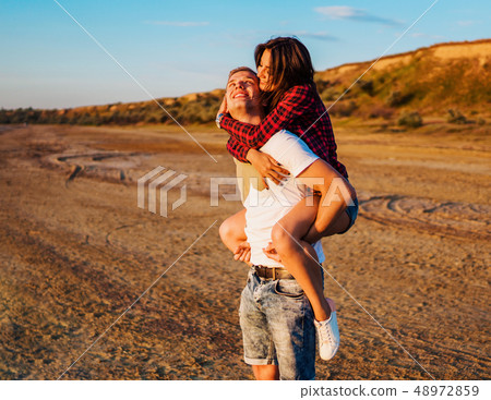 lovestory of couple on the beach On the Sunset 48972859
