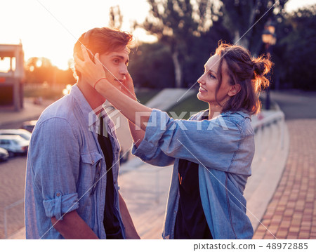 Lovely young hipster couple dating during summer sunset. Lovely young hipster couple dating during summer sunset. 48972885