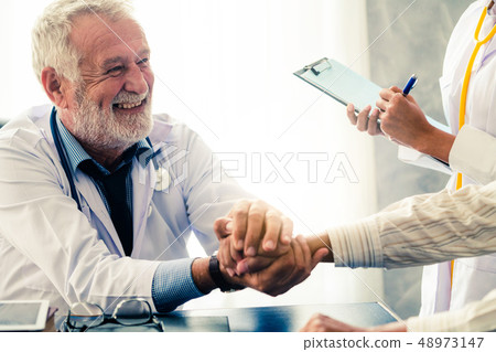 Senior doctor talking to patient in the hospital. Senior doctor talking to patient in the hospital. 48973147