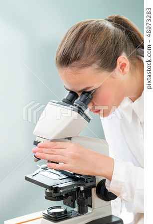 Scientist researcher uses microscope in laboratory Scientist researcher uses microscope in laboratory 48973283