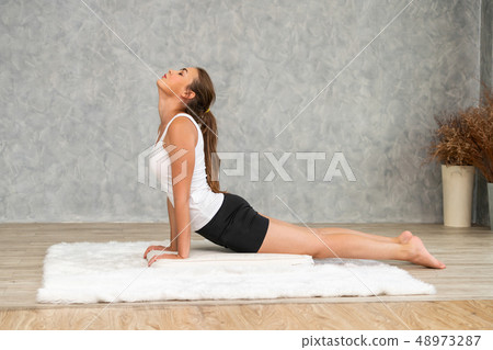 Young woman yoga on carpet at home living room. Young woman yoga on carpet at home living room. 48973287