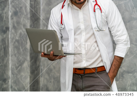 Doctor using laptop computer at the hospital. Doctor using laptop computer at the hospital. 48973345