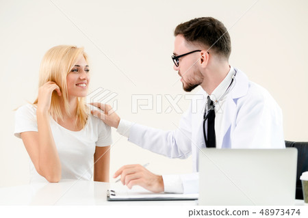 Male Doctor and Female Patient in Hospital Office 48973474