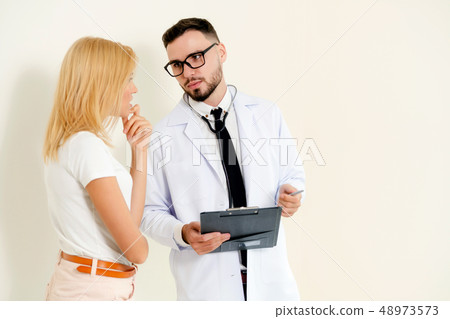 Male Doctor and Female Patient in Hospital Office 48973573