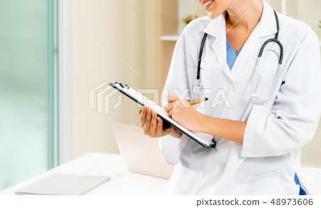 Young female doctor working in hospital office. 48973606