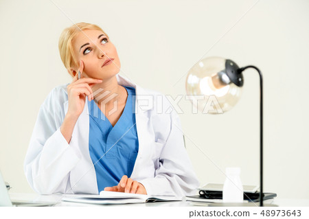 Doctor in hospital working on medical report. Doctor in hospital working on medical report. 48973643
