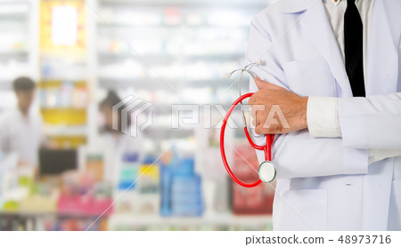 Male pharmacist working at the pharmacy. 48973716