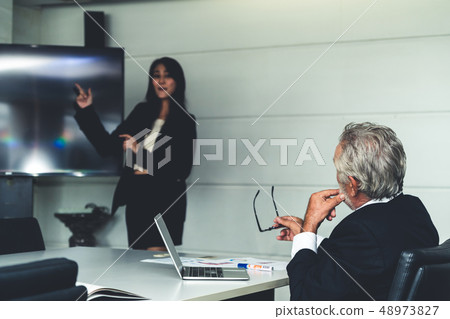 Businesswoman presents senior executive manager. Businesswoman presents senior executive manager. 48973827
