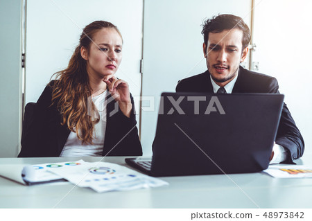 Unhappy serious businessman and businesswoman. Unhappy serious businessman and businesswoman. 48973842