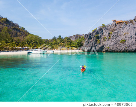tourist kayaking on clear water  48973865