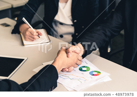 Business people handshake agreement in office. Business people handshake agreement in office. 48973978