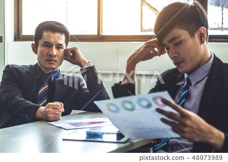 Unhappy business manager and young businessman. 48973989