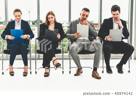 Businesswomen and businessmen wait for interview. Businesswomen and businessmen wait for interview. 48974142