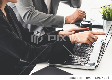 Businessman and businesswoman working in office. Businessman and businesswoman working in office. 48974201