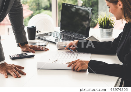 Architect and engineer working with drawing. 48974203