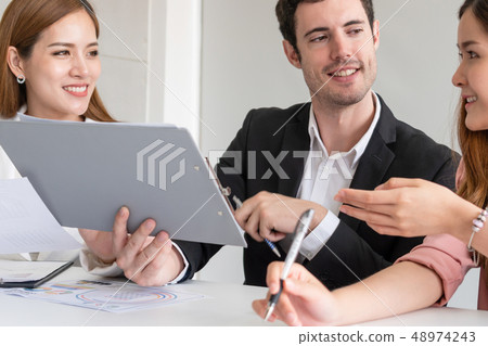 Businessman and businesswomen working in office. Businessman and businesswomen working in office. 48974243