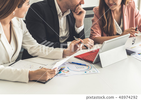 Businessman and businesswomen working in office. 48974292